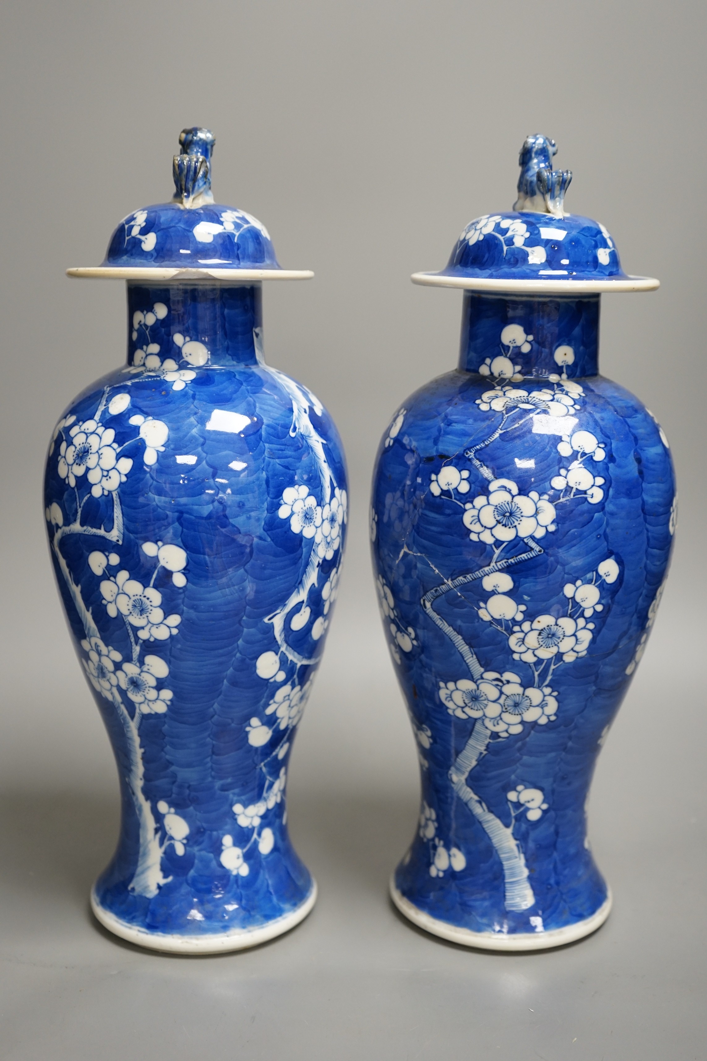 A pair of 19th century Chinese blue and white prunus vases, one a.f, 37cm